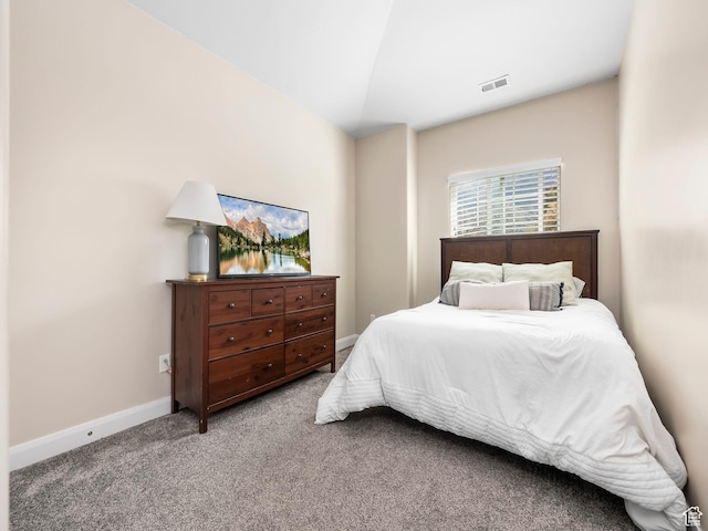 carpeted bedroom with baseboards, visible vents, and lofted ceiling