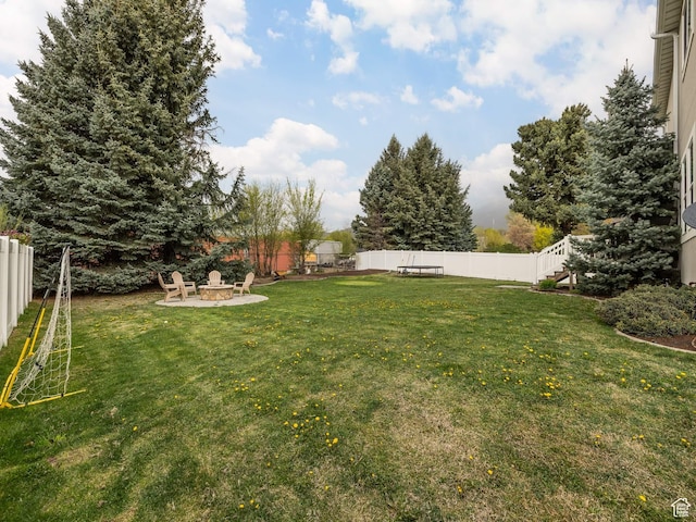 view of yard with a fire pit and a fenced backyard