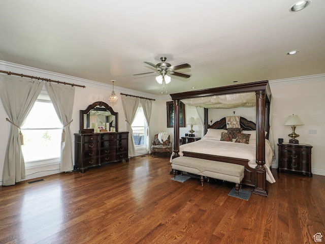 bedroom with wood finished floors, visible vents, crown molding, and recessed lighting