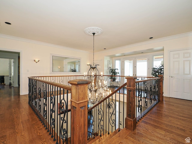 hallway with an upstairs landing, a chandelier, and ornamental molding