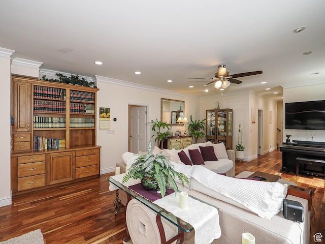 living room with dark wood finished floors, baseboards, a ceiling fan, and crown molding