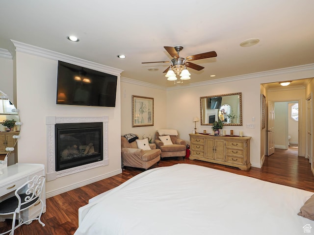 bedroom with recessed lighting, wood finished floors, a high end fireplace, ceiling fan, and crown molding