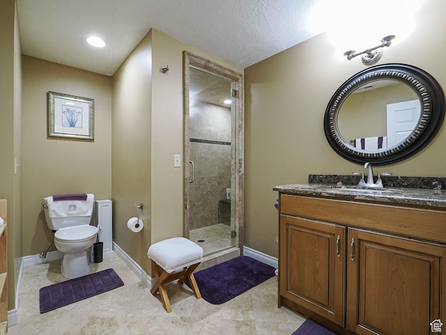 full bathroom featuring tile patterned flooring, toilet, vanity, baseboards, and a stall shower