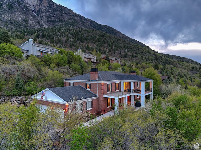 exterior space featuring a mountain view and a view of trees