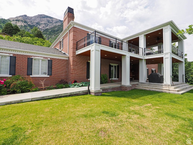 4545 S Abinadi Rd, Salt Lake City, UT 84124 - rear view of property featuring a balcony, a yard, and brick siding
