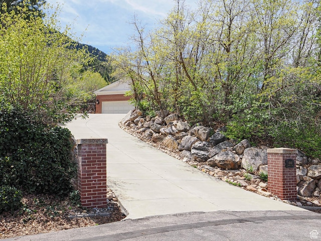 view of home's exterior with concrete driveway and brick siding