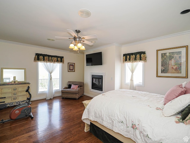 bedroom with access to exterior, baseboards, a glass covered fireplace, ornamental molding, and wood finished floors