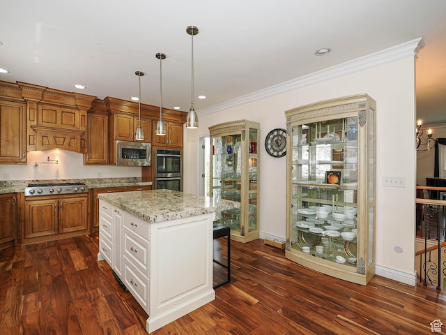 kitchen featuring dark wood finished floors, stainless steel appliances, a kitchen breakfast bar, and brown cabinets