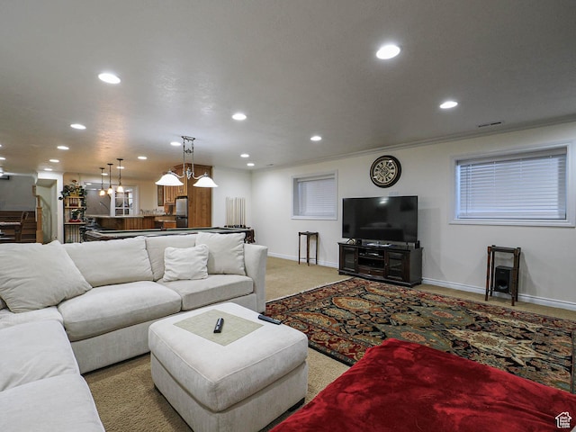 living area with visible vents, recessed lighting, light carpet, and baseboards