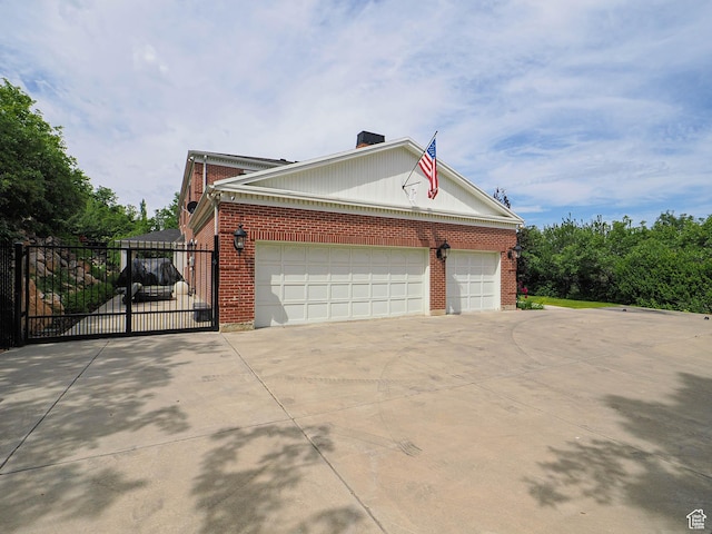 4545 S Abinadi Rd, Salt Lake City, UT 84124 - view of property exterior featuring brick siding, concrete driveway, a gate, a chimney, and a garage