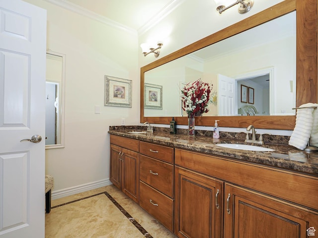 full bath featuring ornamental molding, double vanity, a sink, and baseboards