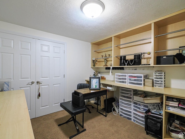 office area with a textured ceiling and carpet floors