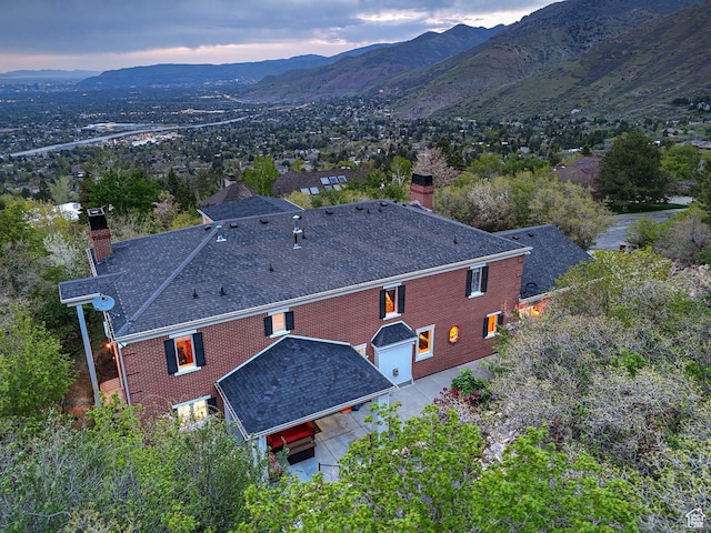 aerial view at dusk featuring a mountain view