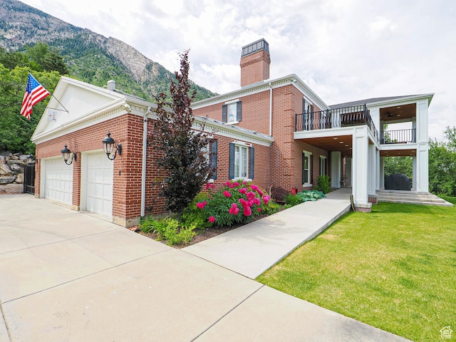 4545 S Abinadi Rd, Salt Lake City, UT 84124 - view of front of home featuring a chimney, a mountain view, a balcony, and brick siding