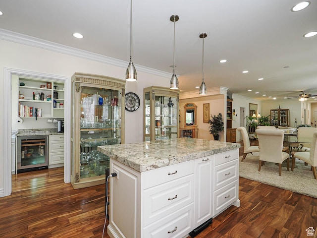 kitchen featuring beverage cooler, dark wood-style flooring, crown molding, and recessed lighting