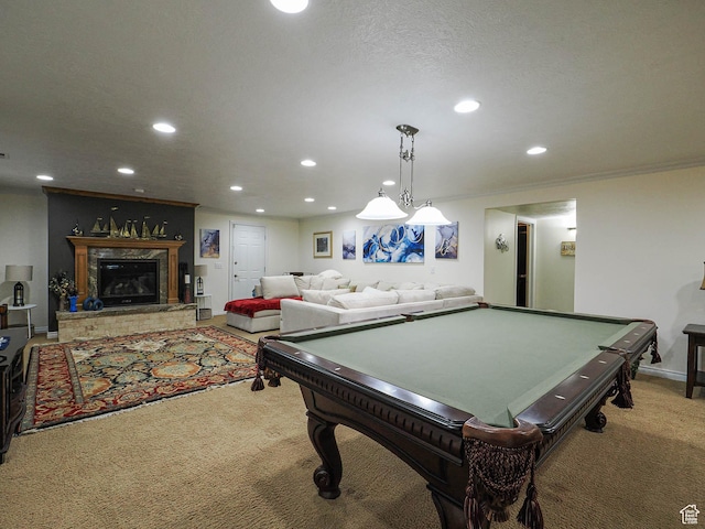 rec room featuring recessed lighting, pool table, ornamental molding, carpet flooring, and a glass covered fireplace