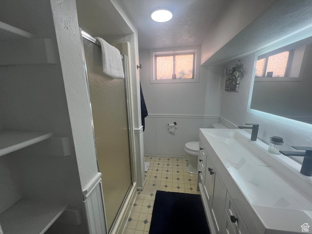 240 S 100 E, Logan, UT 84321 - bathroom featuring a textured ceiling, a shower stall, vanity, tile patterned floors, and toilet