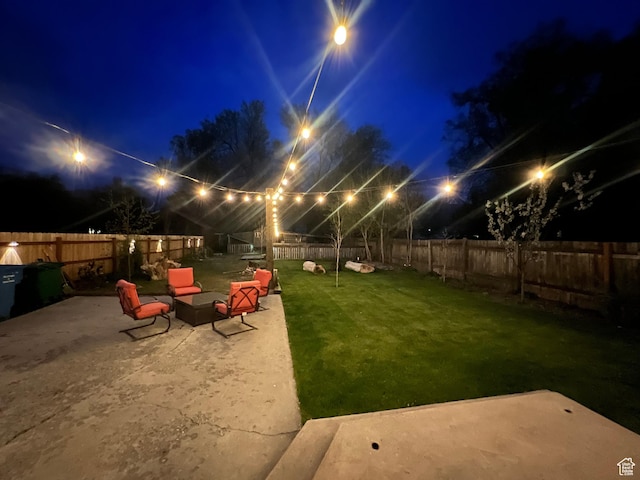 240 S 100 E, Logan, UT 84321 - yard at night featuring a fenced backyard and a patio area
