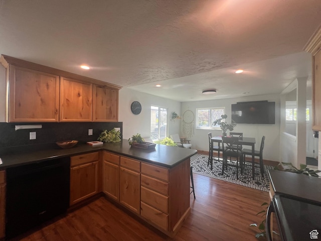 240 S 100 E, Logan, UT 84321 - kitchen with range, dark countertops, dark wood finished floors, a peninsula, and recessed lighting