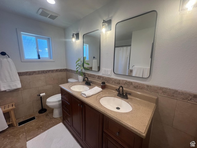 240 S 100 E, Logan, UT 84321 - bathroom with tile walls, a sink, and visible vents