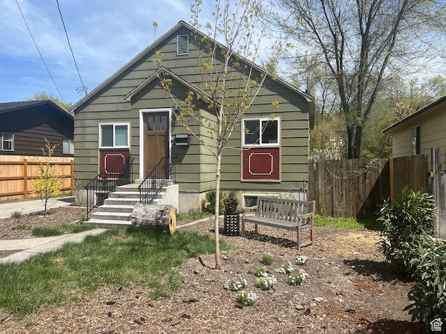 bungalow-style house featuring fence and entry steps