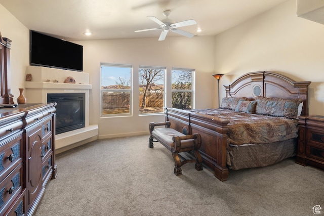 3686 S Spanish Valley Dr Unit W-4, Moab, UT 84532 - bedroom featuring a glass covered fireplace, carpet flooring, baseboards, a ceiling fan, and vaulted ceiling