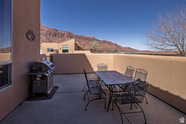 3686 S Spanish Valley Dr Unit W-4, Moab, UT 84532 - view of patio featuring a mountain view, outdoor dining space, and a grill
