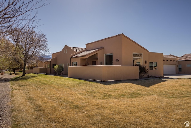 3686 S Spanish Valley Dr Unit W-4, Moab, UT 84532 - view of side of property with stucco siding, a garage, fence, and a tiled roof
