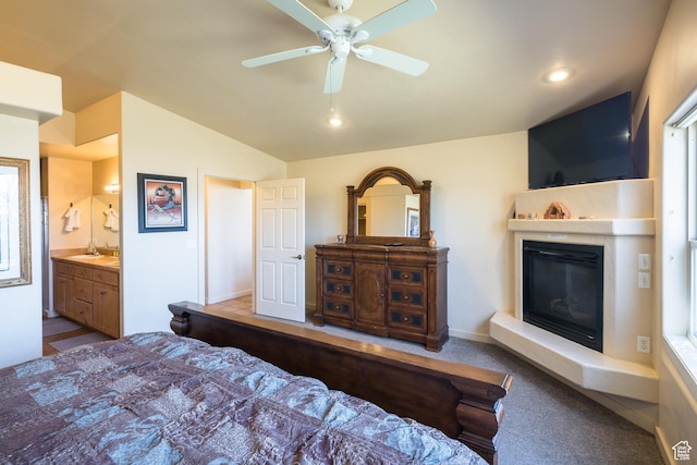 3686 S Spanish Valley Dr Unit W-4, Moab, UT 84532 - carpeted bedroom featuring a ceiling fan, vaulted ceiling, a sink, connected bathroom, and a glass covered fireplace