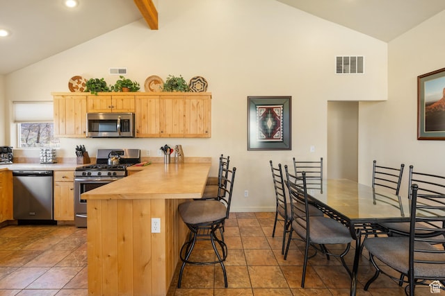 3686 S Spanish Valley Dr Unit W-4, Moab, UT 84532 - kitchen with appliances with stainless steel finishes, light brown cabinets, high vaulted ceiling, and visible vents