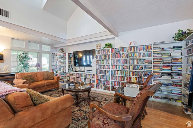 54 Cottonwood Ln, Hurricane, UT 84737 - living area featuring visible vents, wood finished floors, bookshelves, and high vaulted ceiling