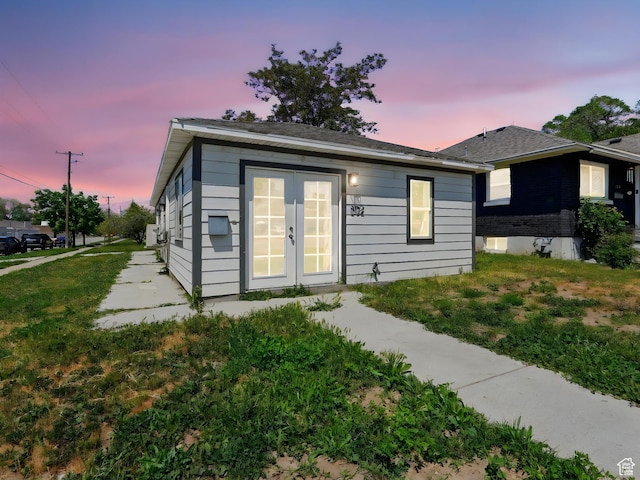 302 34th St, Ogden, UT 84401 - back of house at dusk featuring french doors