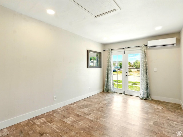 302 34th St, Ogden, UT 84401 - empty room featuring a wall unit AC, baseboards, wood finished floors, recessed lighting, and french doors