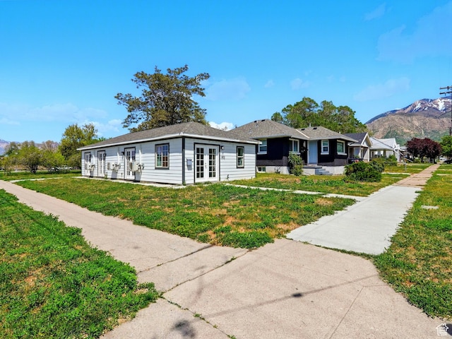 302 34th St, Ogden, UT 84401 - view of front of home featuring french doors, a front lawn, and a mountain view