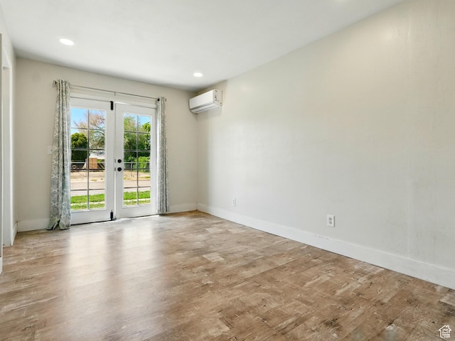 302 34th St, Ogden, UT 84401 - spare room featuring a wall mounted AC, wood finished floors, baseboards, french doors, and recessed lighting