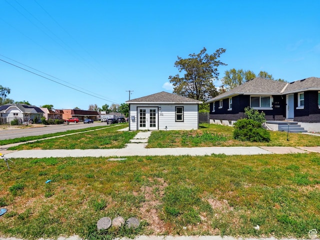 302 34th St, Ogden, UT 84401 - view of front of house with french doors, a front yard, and a residential view