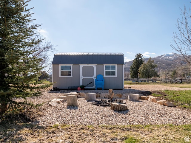 641 W 500 S, Midway, UT 84049 - rear view of house with a storage shed, a mountain view, an outbuilding, fence, and metal roof