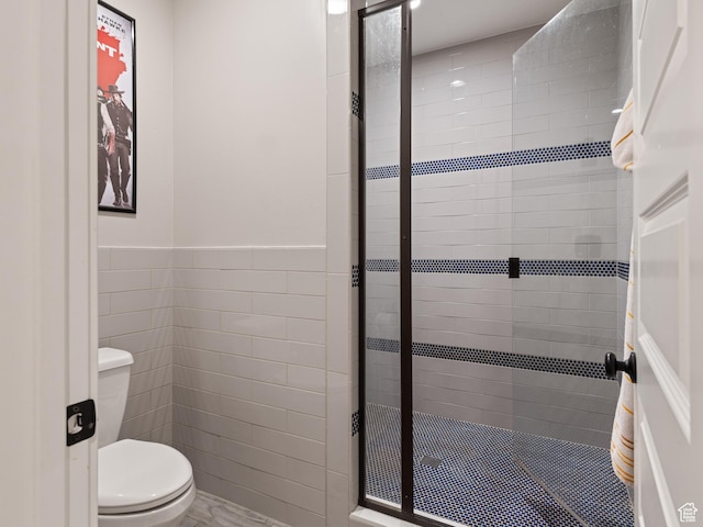 641 W 500 S, Midway, UT 84049 - full bathroom featuring tile walls, a stall shower, toilet, and wainscoting