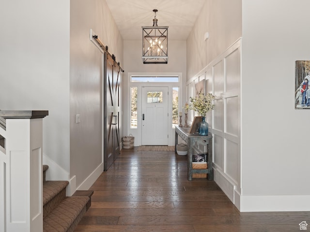641 W 500 S, Midway, UT 84049 - foyer entrance featuring a barn door, dark wood-style floors, stairway, a chandelier, and baseboards