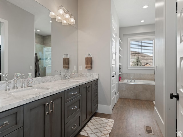 641 W 500 S, Midway, UT 84049 - full bathroom with wood finished floors, a stall shower, double vanity, baseboards, and a garden tub