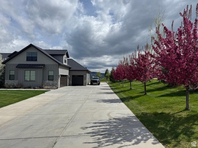 641 W 500 S, Midway, UT 84049 - view of front of property with an attached garage, board and batten siding, driveway, stone siding, and a front yard
