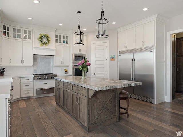 641 W 500 S, Midway, UT 84049 - kitchen featuring built in appliances, light countertops, a center island, dark wood finished floors, and recessed lighting