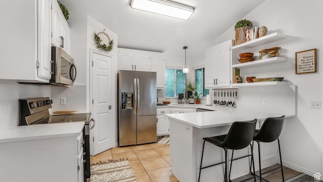5394 W Shaggy Peak Dr, Riverton, UT 84096 - kitchen featuring a sink, stainless steel appliances, a breakfast bar area, a peninsula, and white cabinets