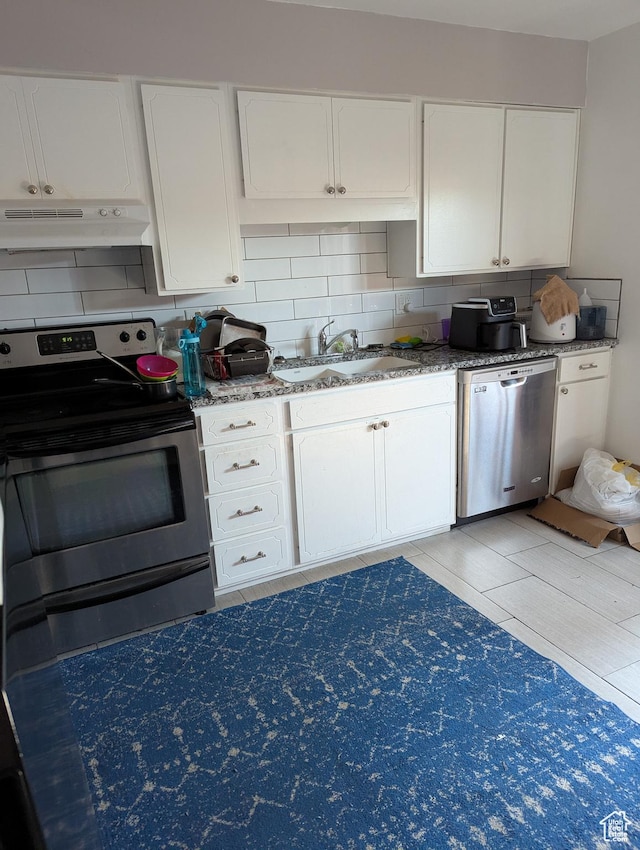 3937 S Lamplighter Way Unit 23, Riverdale, UT 84405 - kitchen featuring stainless steel appliances, under cabinet range hood, a sink, decorative backsplash, and white cabinets