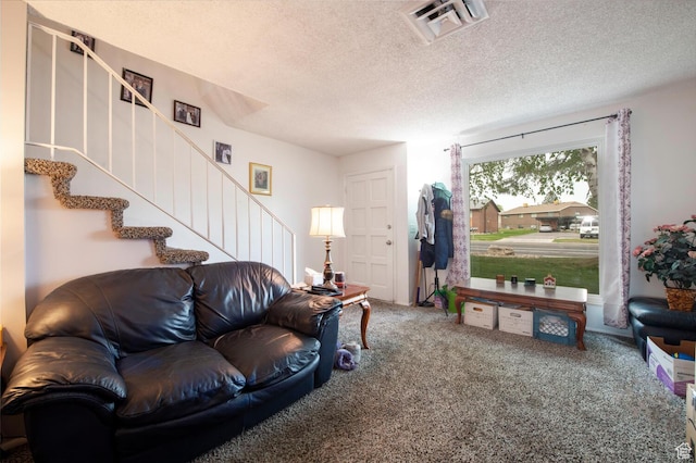 3937 S Lamplighter Way Unit 23, Riverdale, UT 84405 - living room featuring a textured ceiling, visible vents, stairway, and carpet