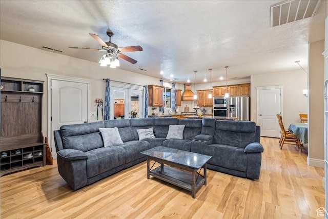 388 E 1060 S, Ivins, UT 84738 - living room with visible vents, light wood-type flooring, a textured ceiling, and ceiling fan
