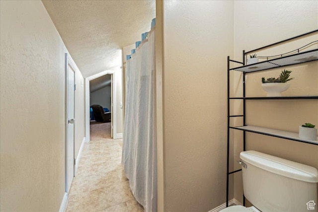 388 E 1060 S, Ivins, UT 84738 - bathroom with a textured ceiling, a textured wall, toilet, and baseboards