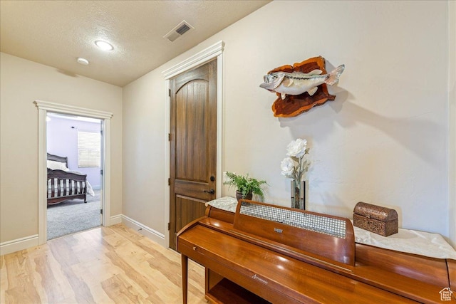 388 E 1060 S, Ivins, UT 84738 - hallway featuring visible vents, light wood-type flooring, a textured ceiling, and baseboards