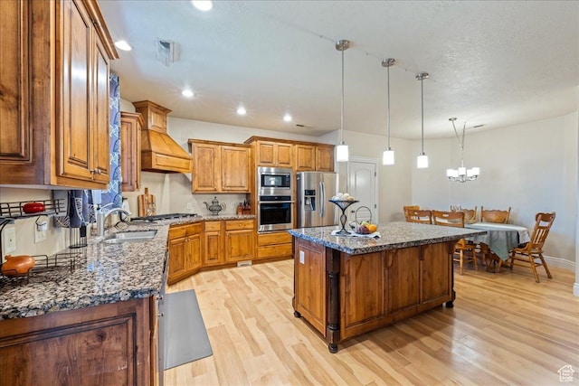 388 E 1060 S, Ivins, UT 84738 - kitchen featuring brown cabinetry, appliances with stainless steel finishes, light wood-style flooring, and premium range hood