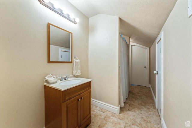 388 E 1060 S, Ivins, UT 84738 - bathroom featuring baseboards, vaulted ceiling, a textured ceiling, and vanity